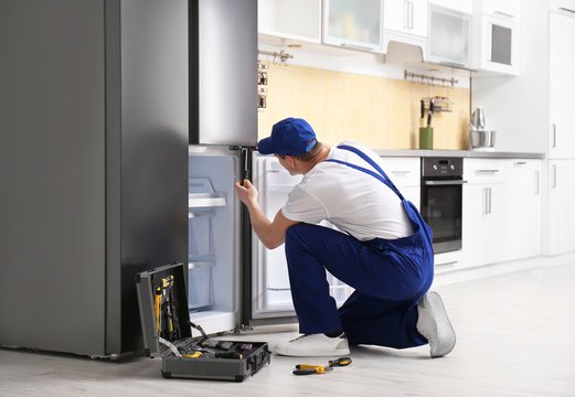 Professional Refrigerator Technician at work